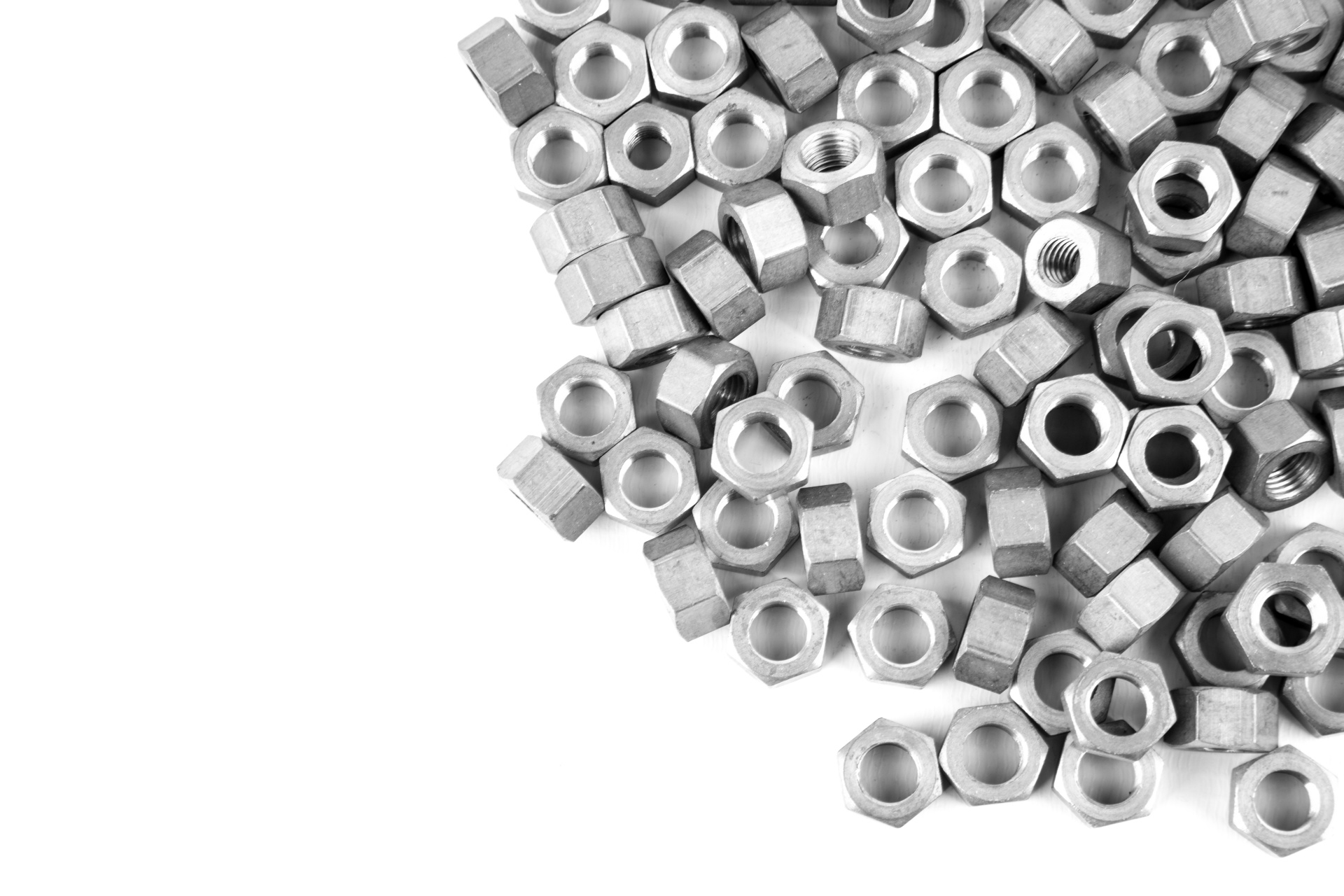 Heap of Metal Screw Steel Nuts isolated on white background