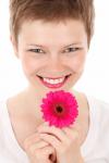 Smiling Woman With A Flower