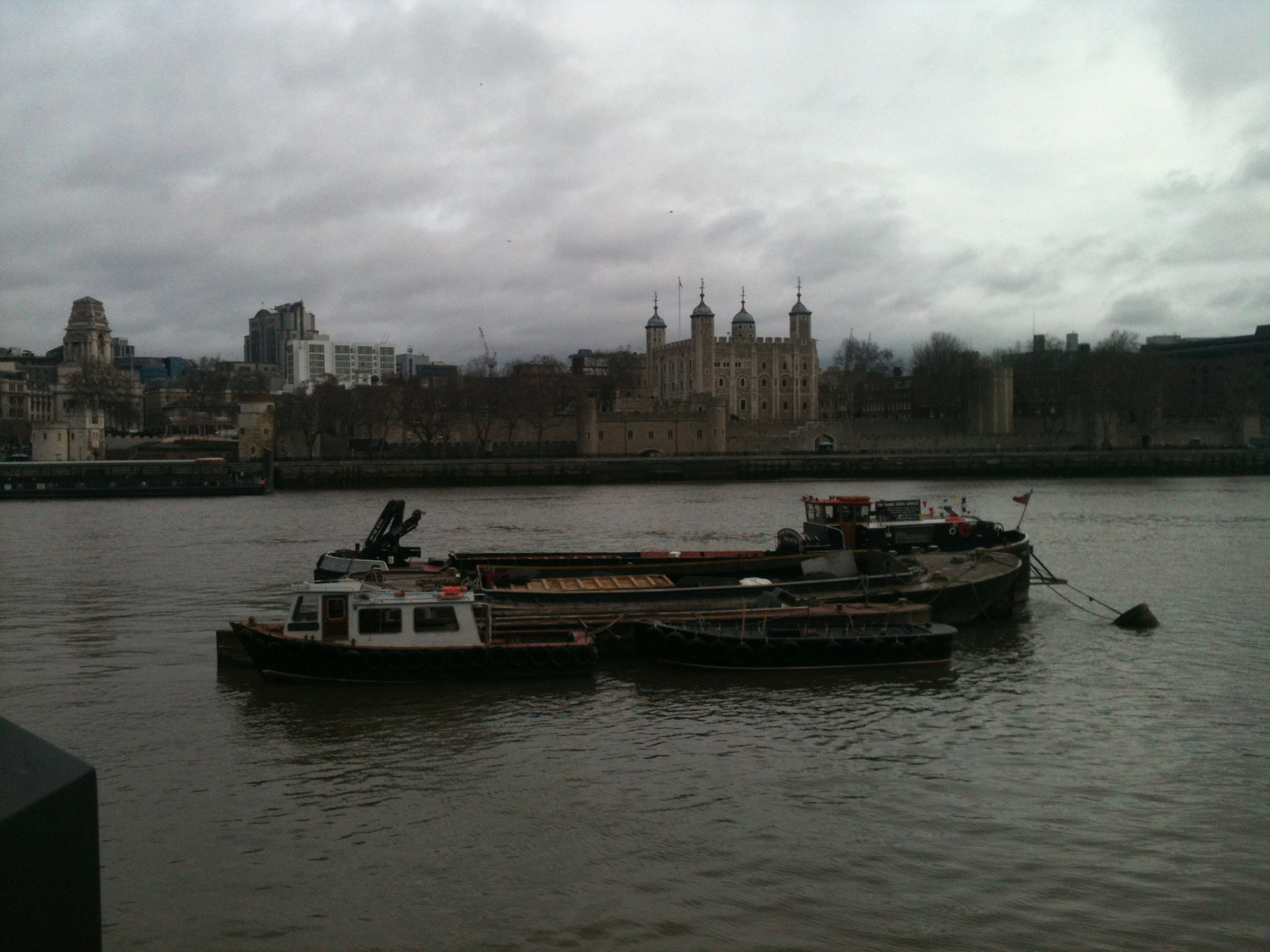 An old river barge on the thames in front of the Tower of London
