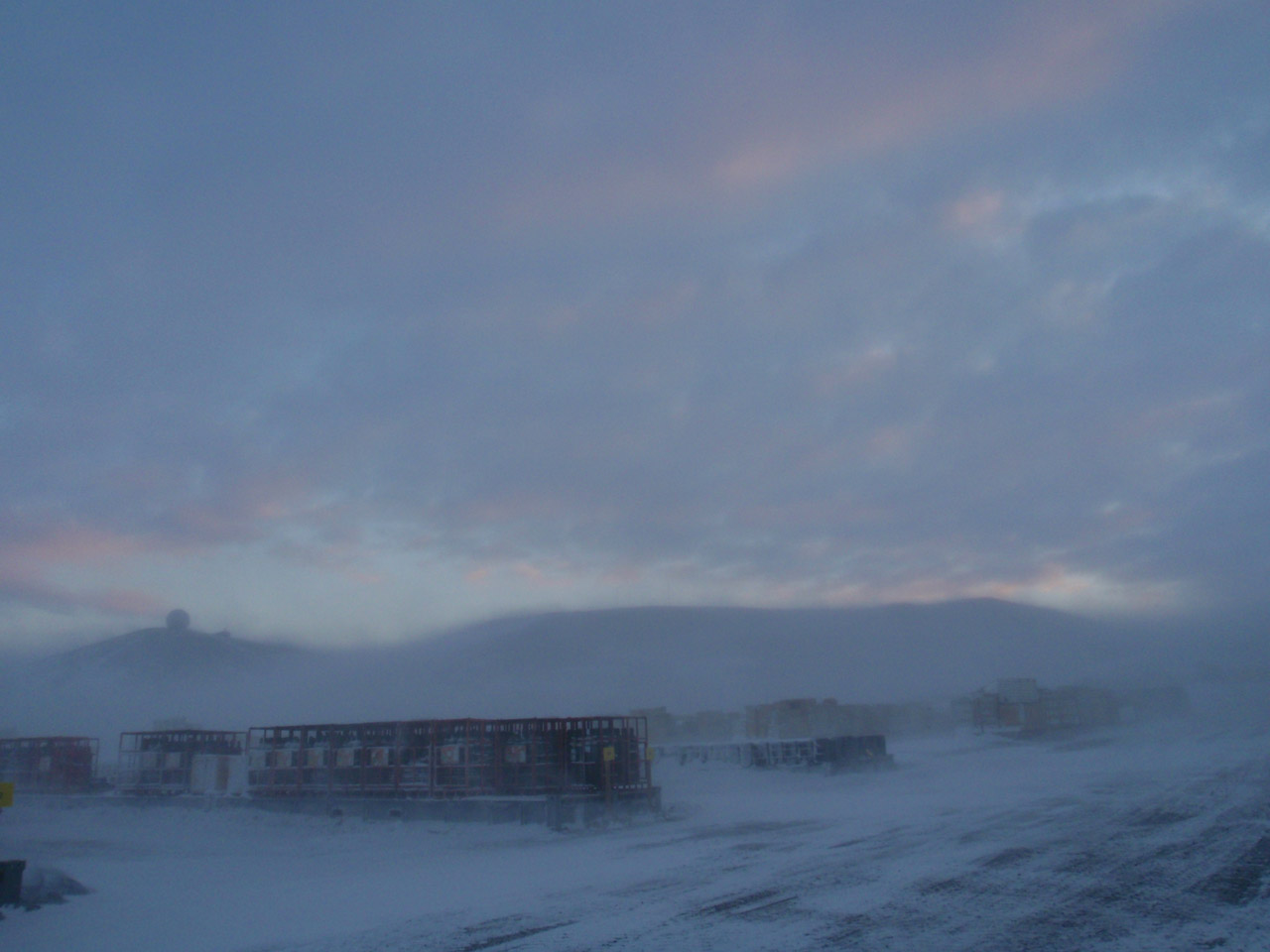 Blowing Snow at "The Ballpark" (storage area) at McMurdo Station, Antarctica.  Although a photograph, the snow gives it an impressionist feel.
