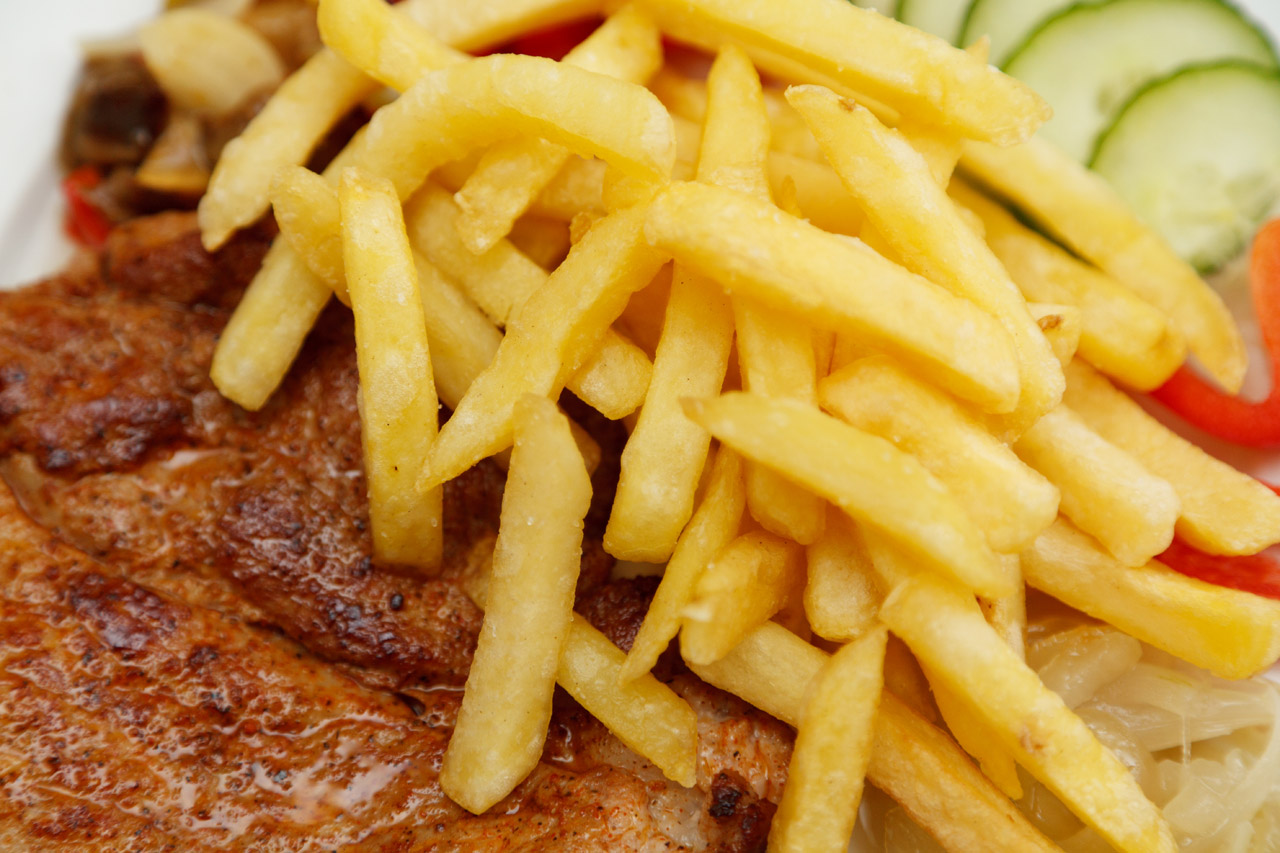 french fries and steak with vegetable detail photo