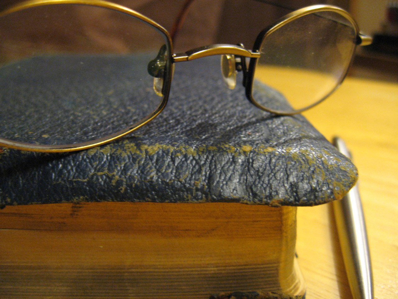 Glasses sitting on an old book.