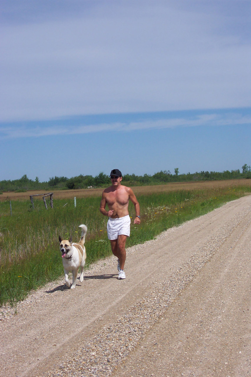 A man jogging with his dog