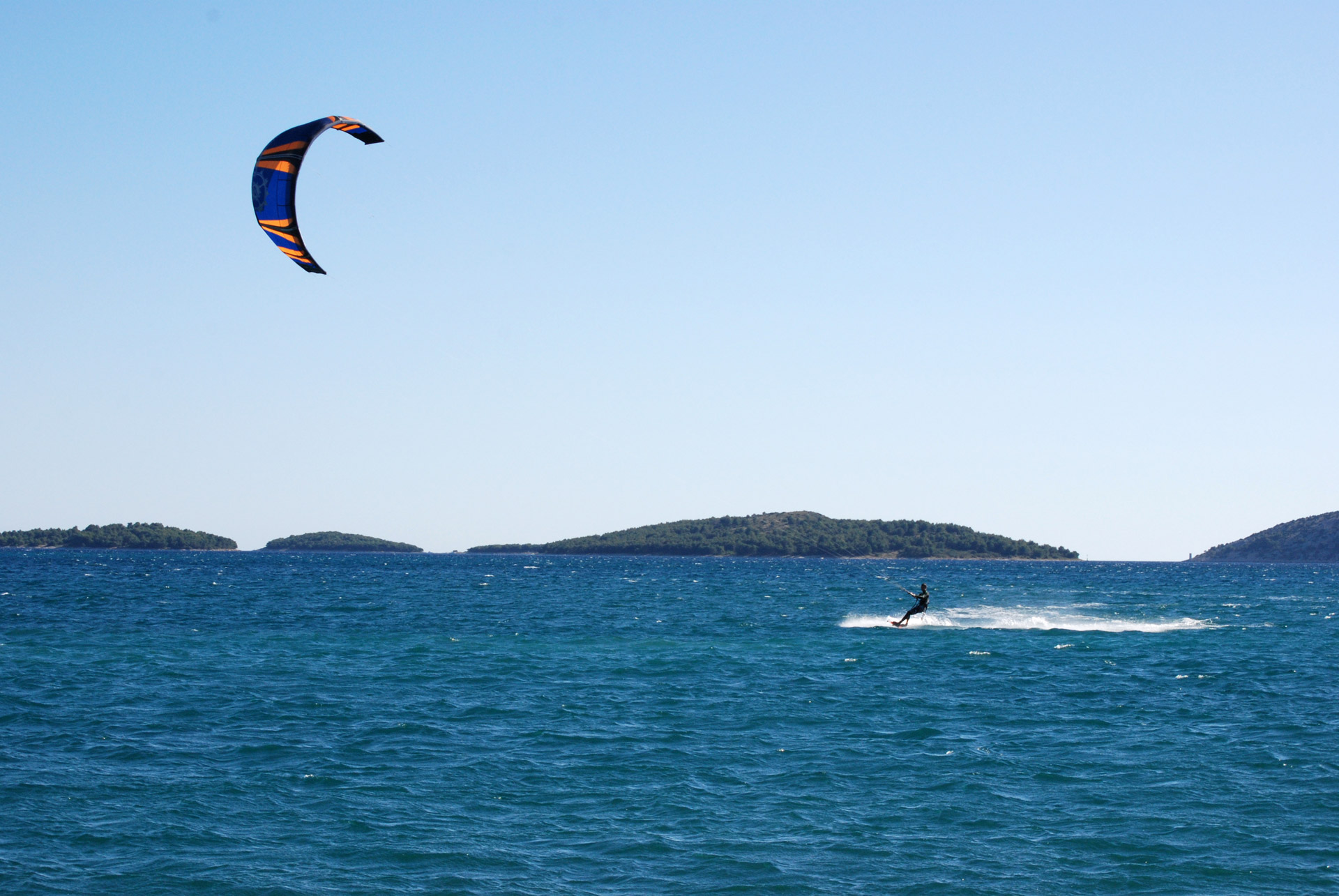 Skillful kite surfer rides the waves at Adriatic Sea
