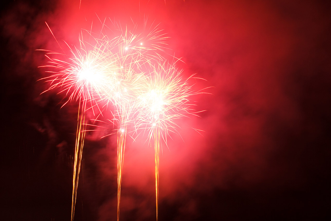 several red fireworks explosion on dark background