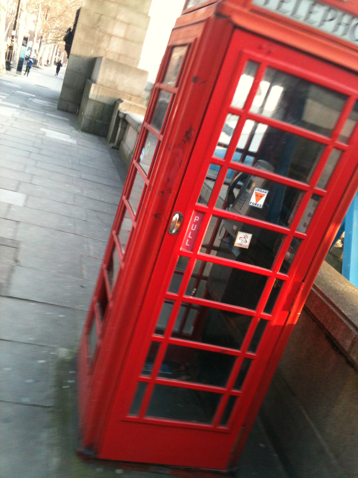 A Red telephone box next to the river Thames