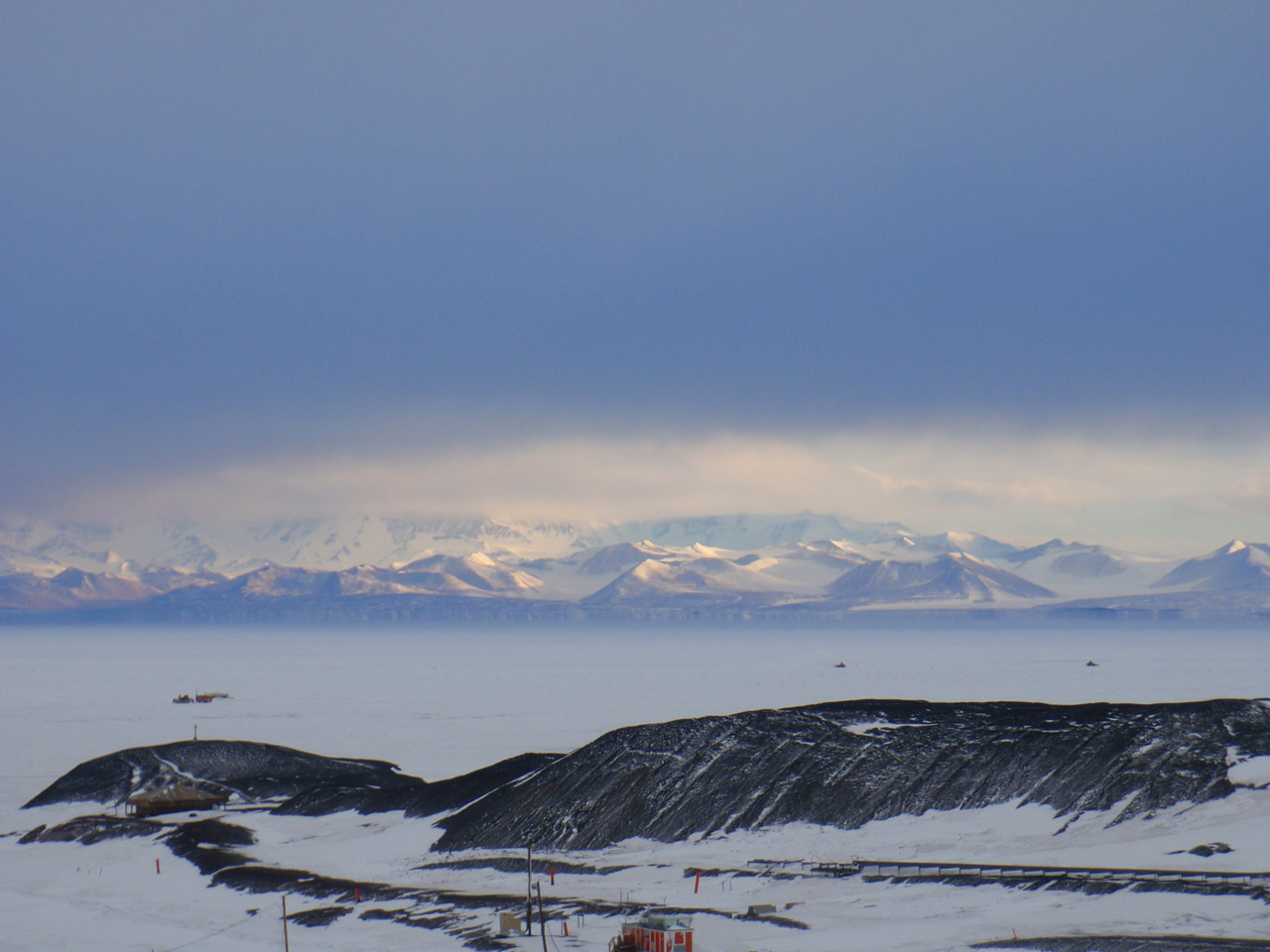 The Royal Society Range seen across the sea ice from McMurdo Station.  A Fata Morgana mirage makes it look like there are steep cliffs at the base of the mountains.