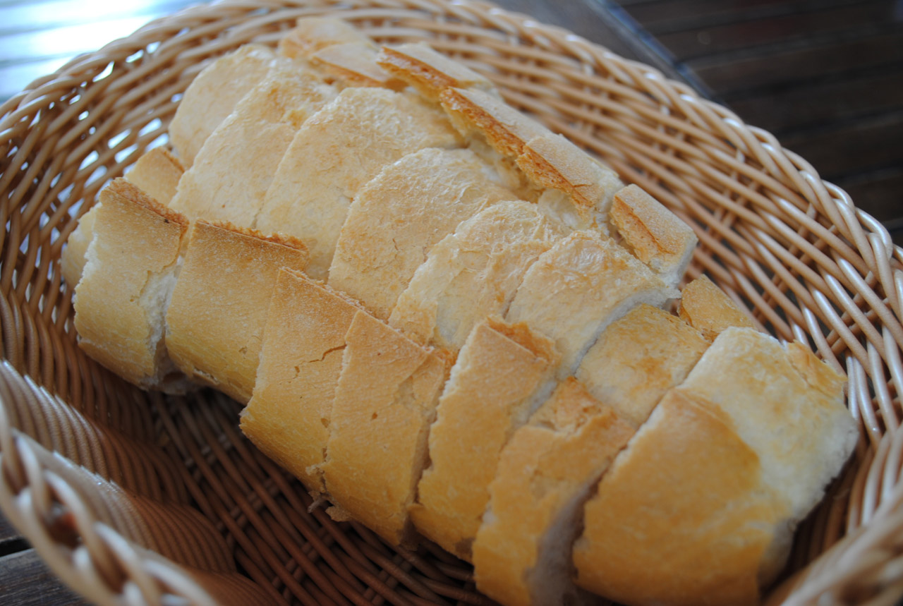 The bread was sliced and placed into a basket.