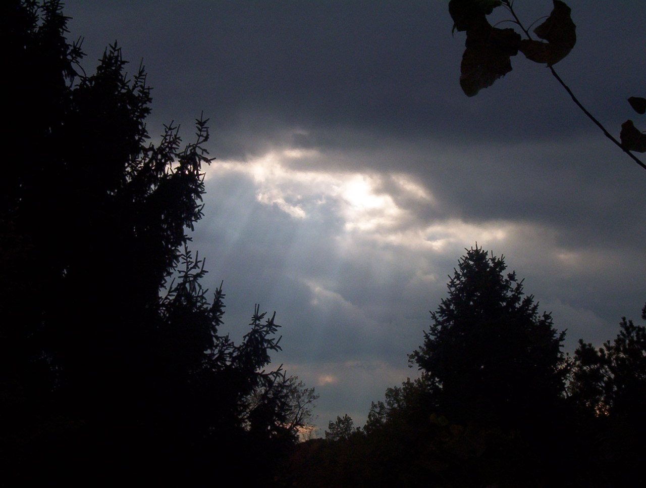 Rays of sunlight through dark clouds