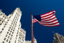 American Flag And City Buildings