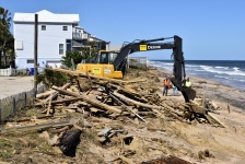 Backhoe Cleaning Up Beach Debris