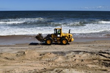 Fork Lift Cleaning Up Beach Debris