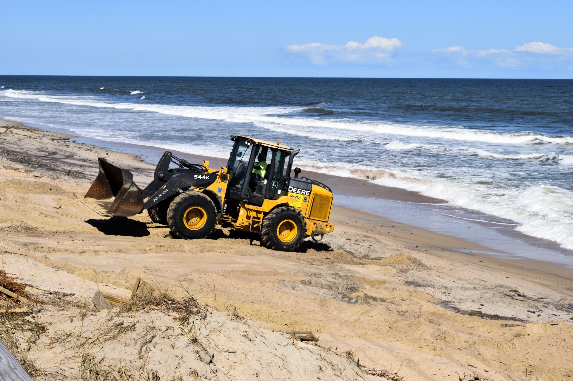 Fork lift cleaning up hurricane Matthew beach debris