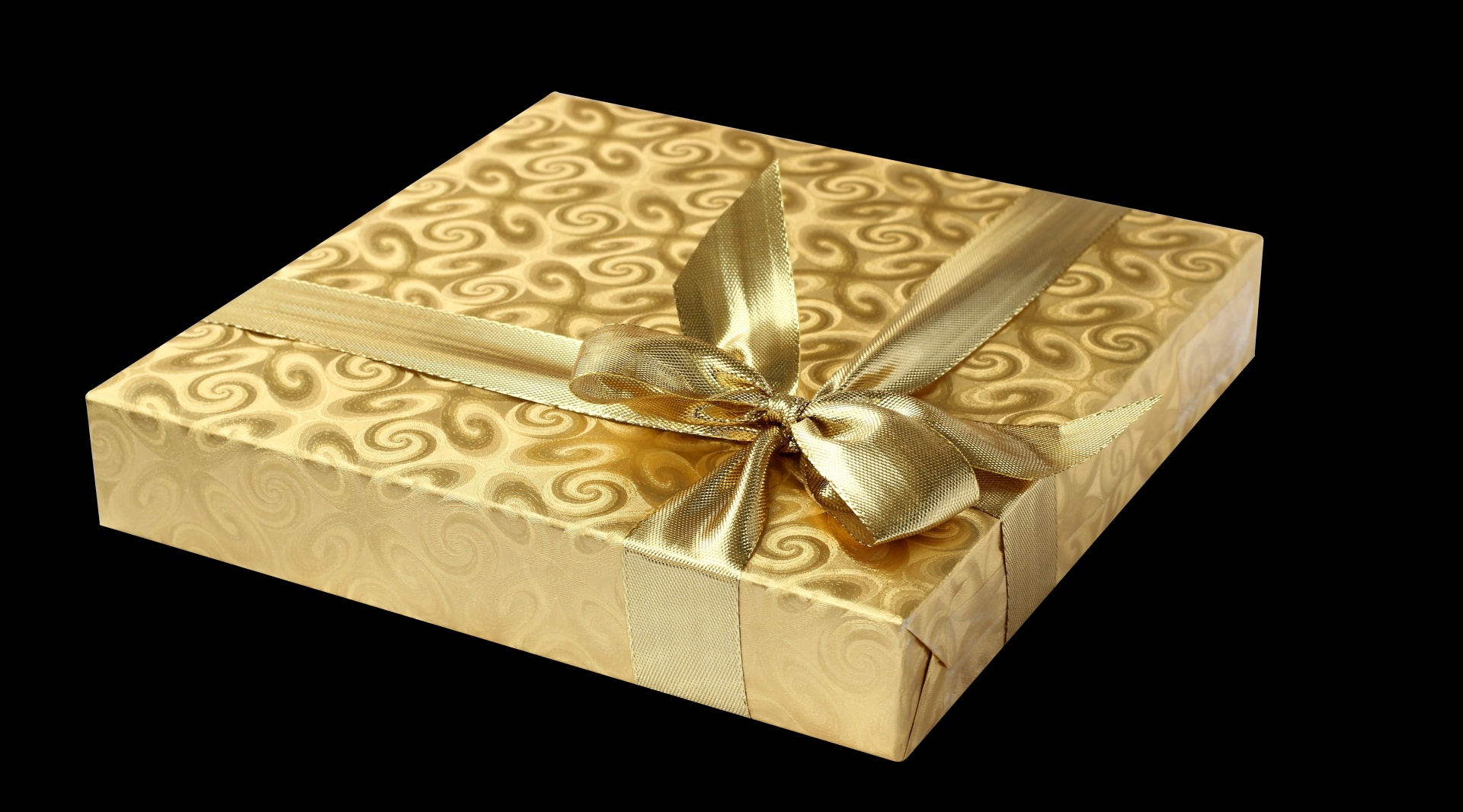 Gold gift box, ribbon and bow isolated on black background
