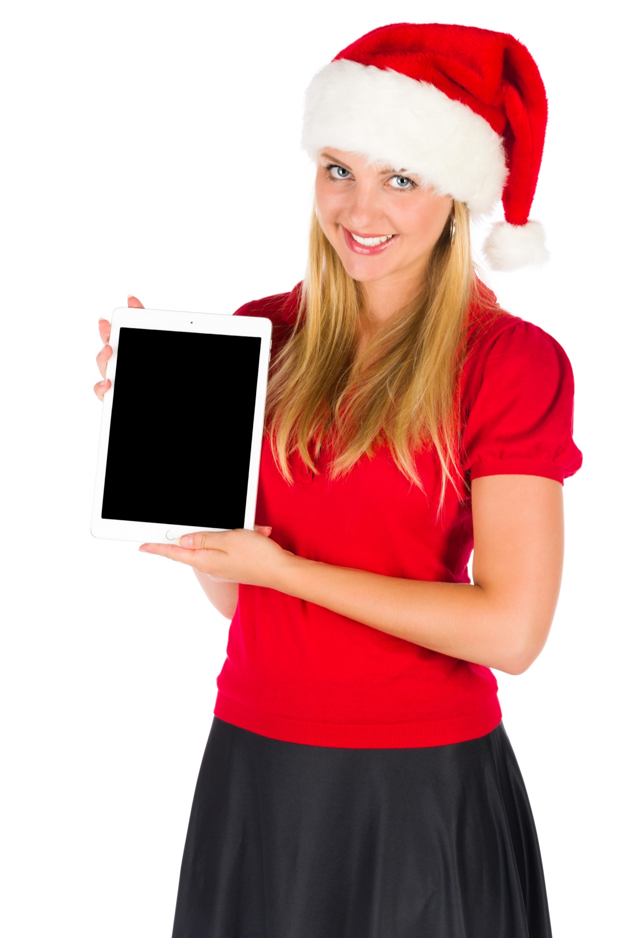 Young woman in a Santa's hat showing a tablet with a blank screen. Isolated on white background