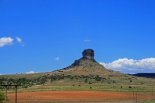 Hill With Butte Under Blue Sky