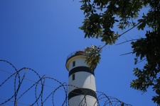 Lighthouse With Tree & Razor Wire