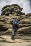 Little Boy Climbing On The Rocks