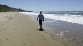 Man Walking Along Beach