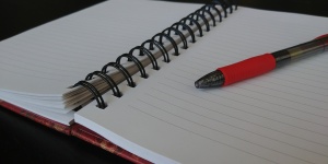 Open Notebook With Red Pen