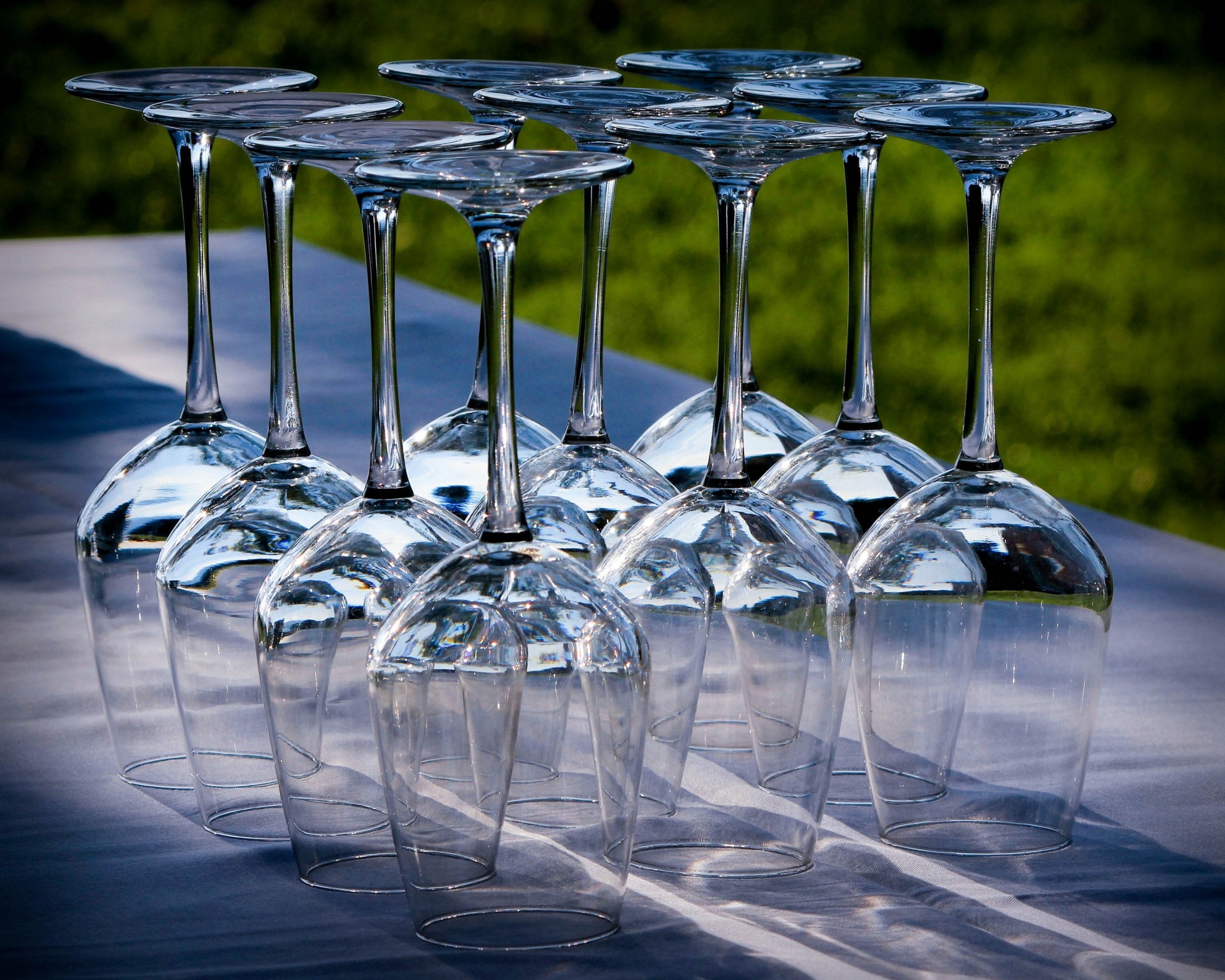Rows of clean and empty wine glasses standing upside down