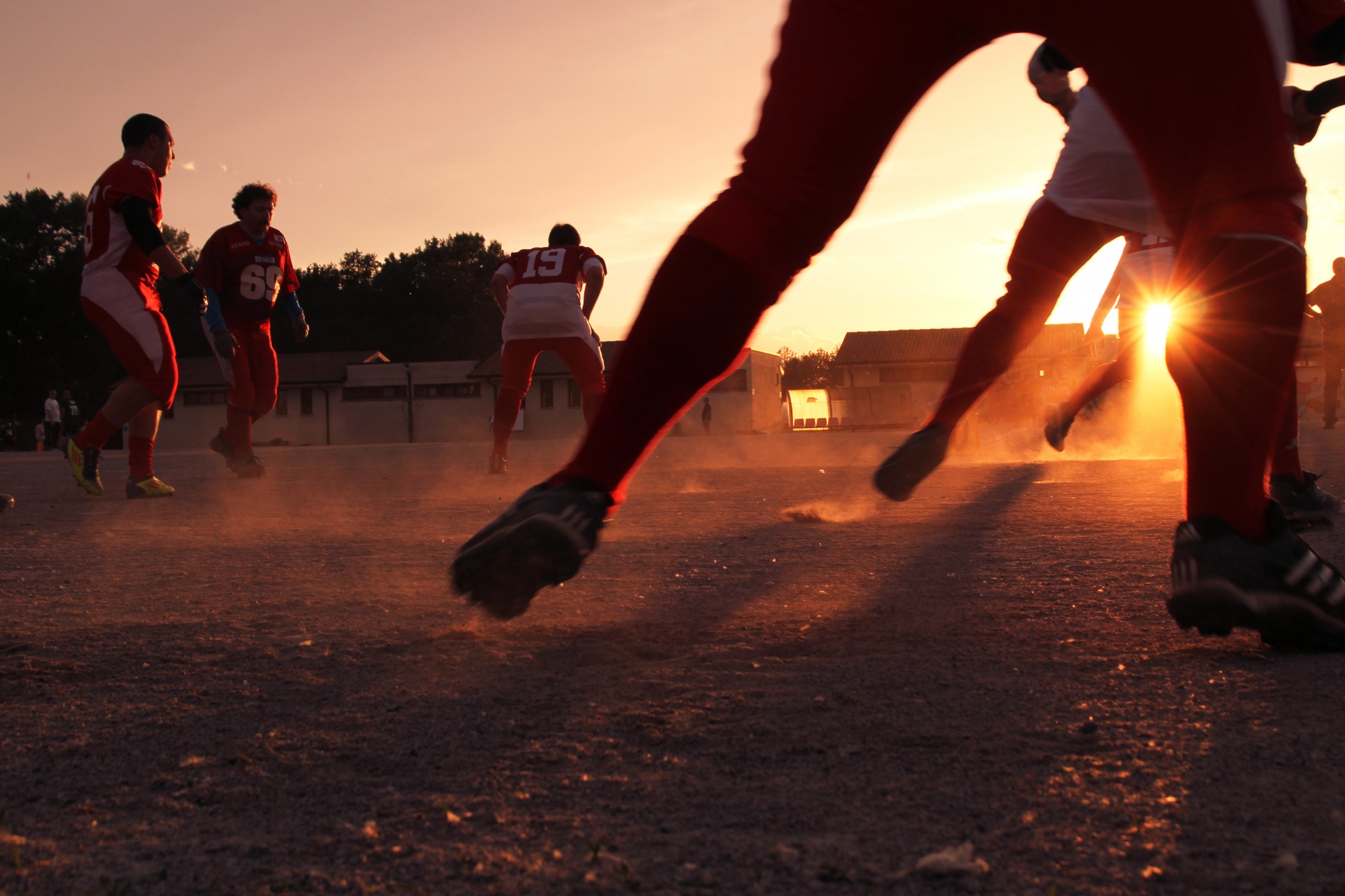 Men playing sport at sunset