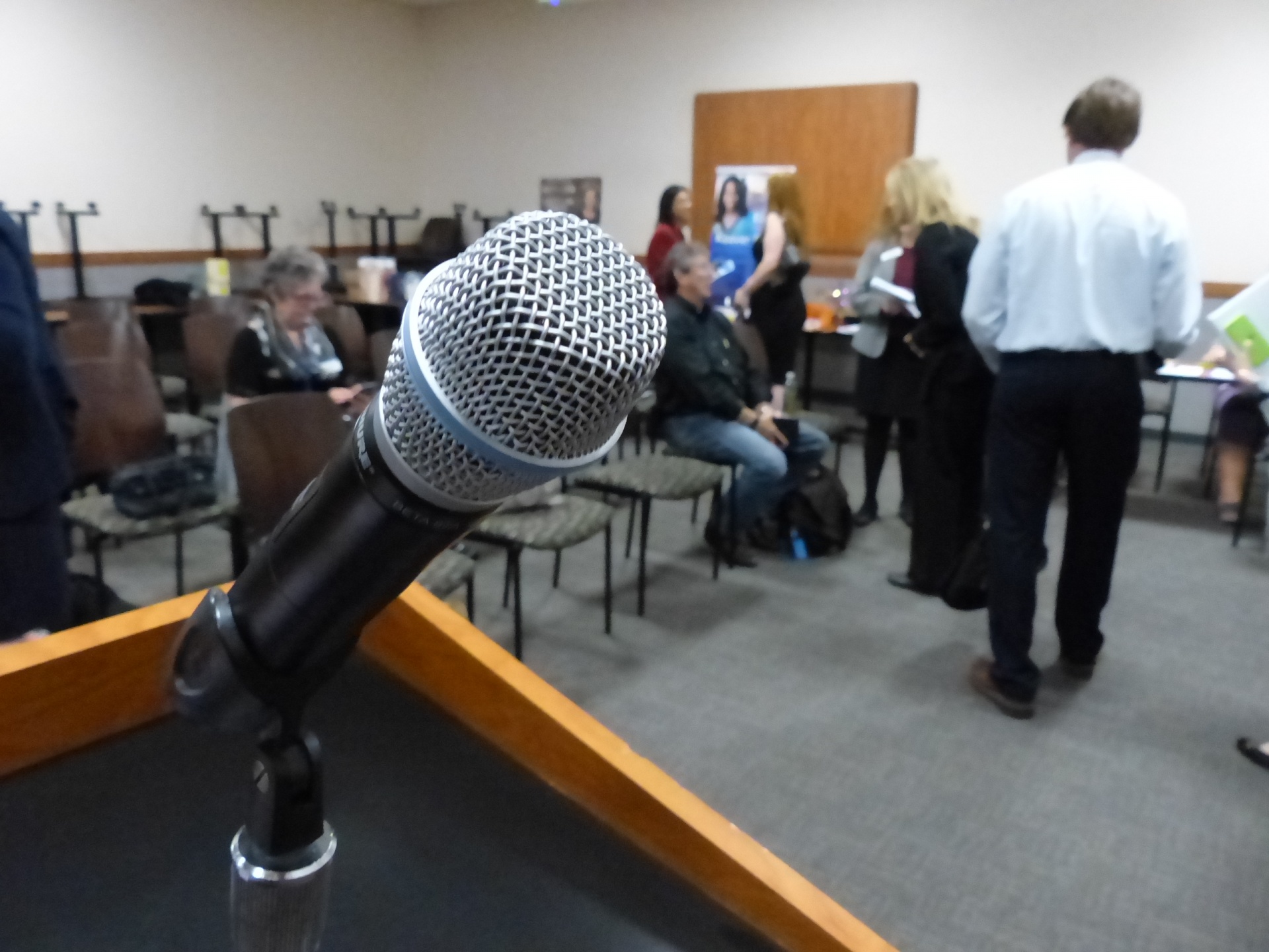 A microphone on a lectern for a speaker to use for a speech to an audience.