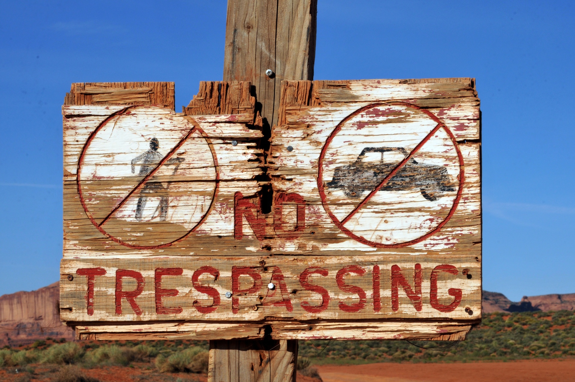 grungy desert worn no trespassing sign
