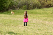 Little Girl And Dog In Field