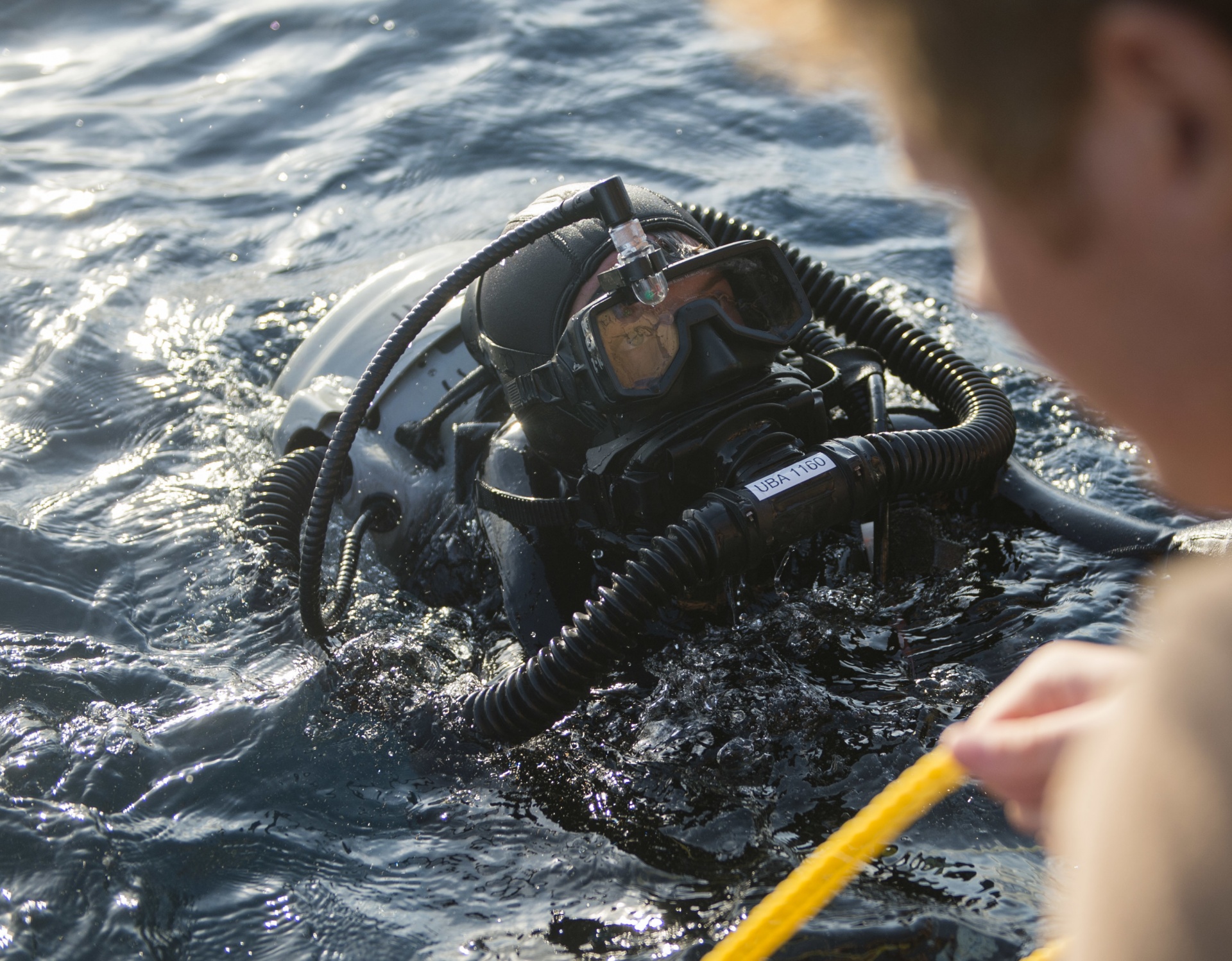 A Sailor assigned to Explosive Ordnance Disposal Mobile Unit EODMU 2, Expeditionary Mine Countermeasures Company ExMCM Co. 202, prepares to dive during Mark 16 dive training.