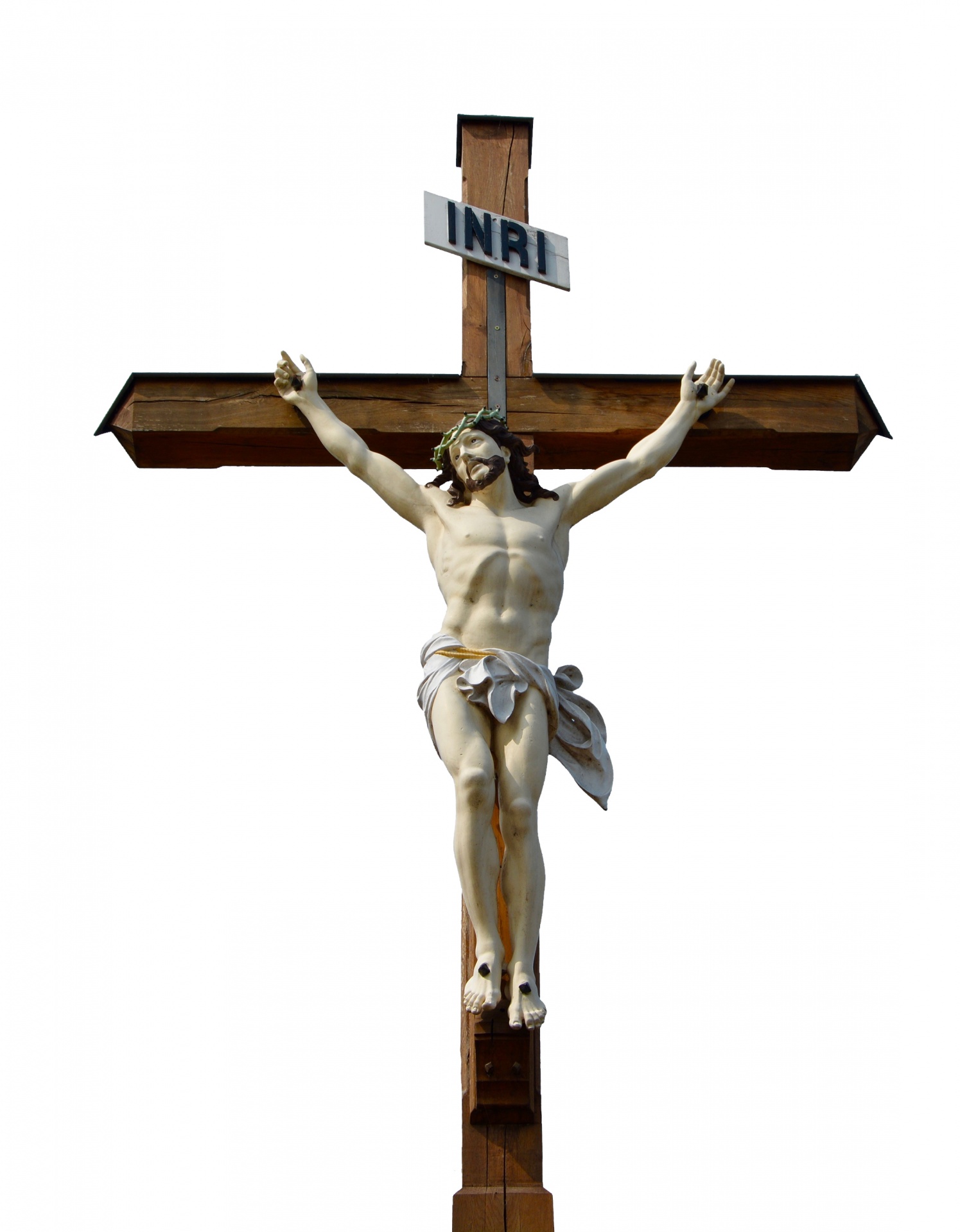 Statue of Jesus Christ on wooden cross isolated on white background