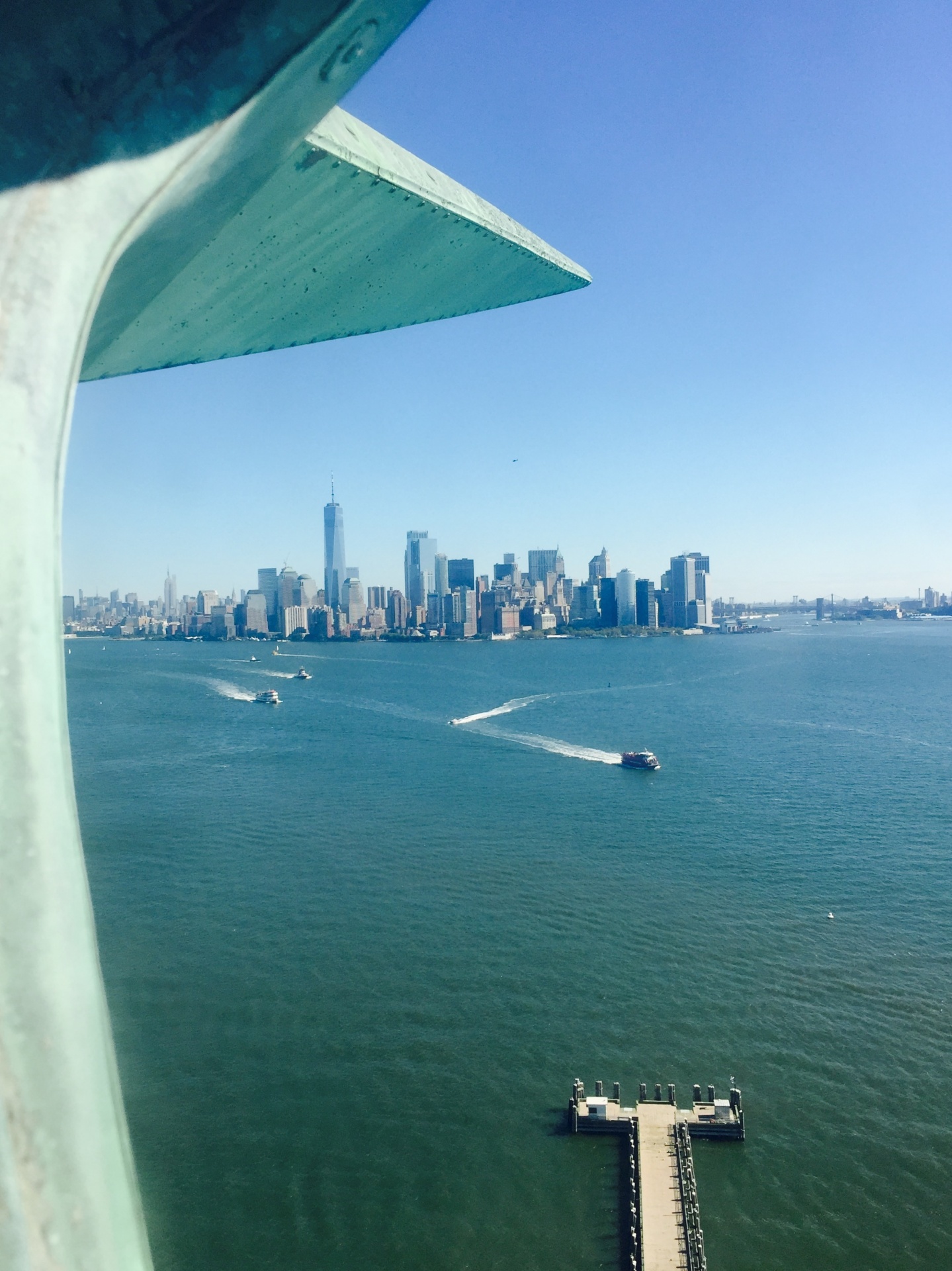 A photo taken from inside the crown of the Statue of Liberty looking East towards New York City