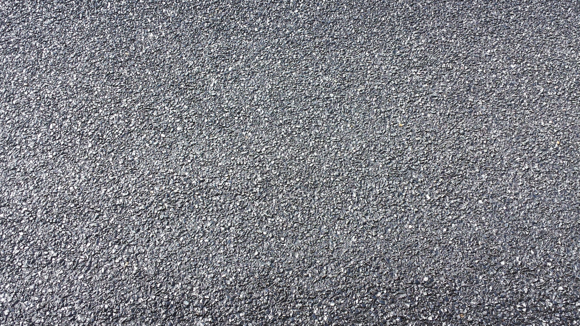 A close-up of a newly resurfaced road