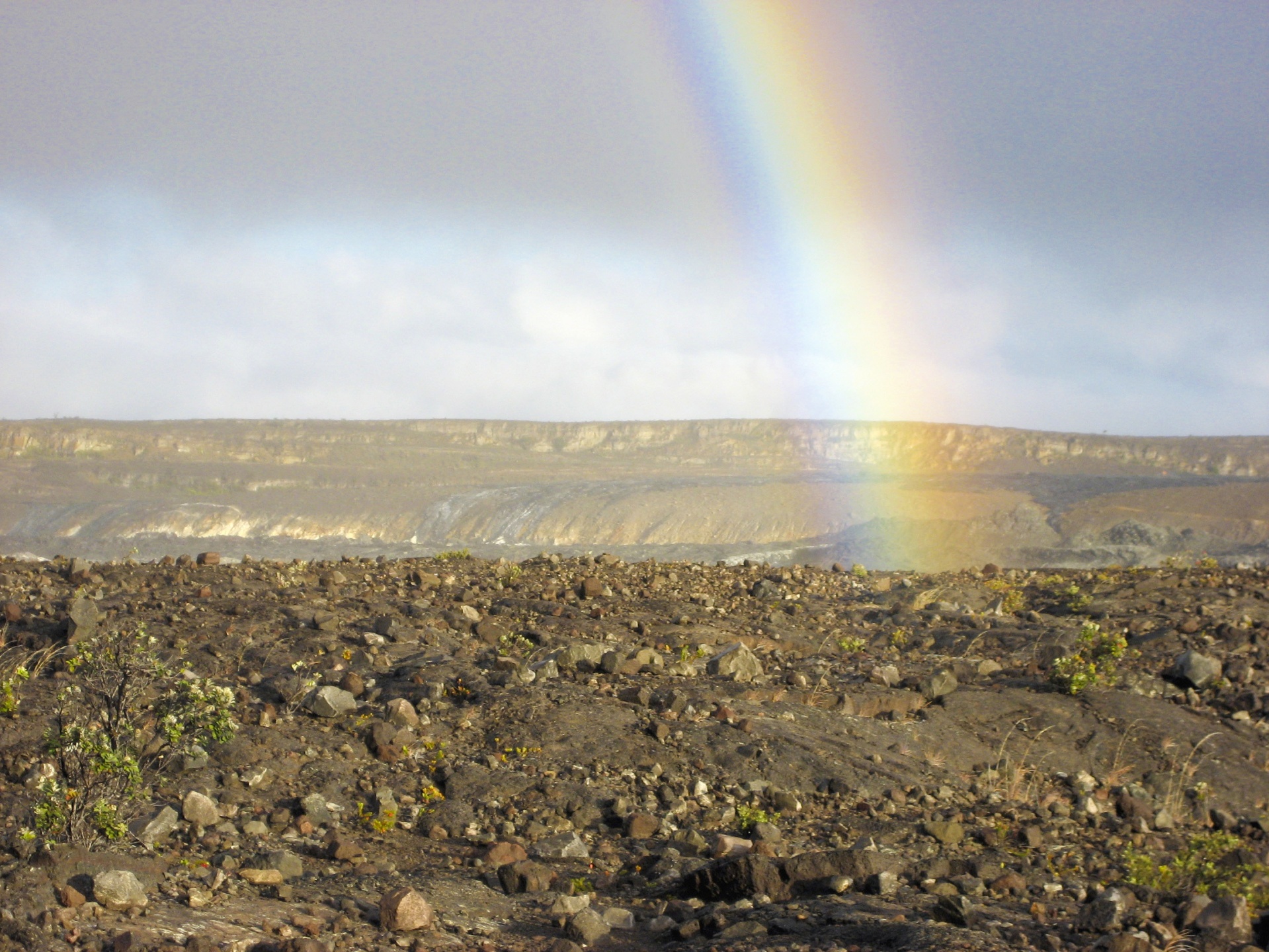 a rainbow in volcanic land