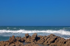 Sea With Rocks And Waves Under Clea