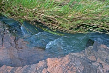 Water Stream Cascading Down Side Of