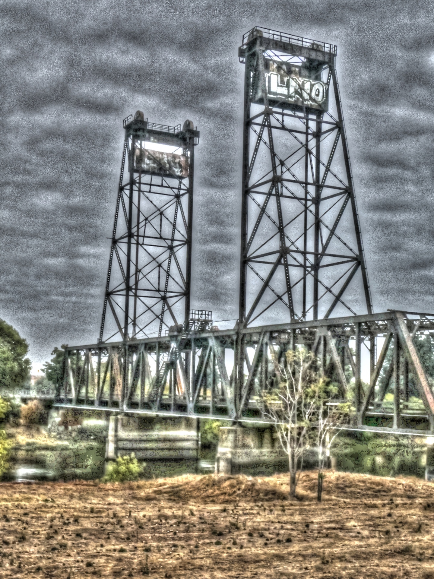artistic touch applied to photograph of old rusty railroad bridge over Deepwater Channel in Stockton, California