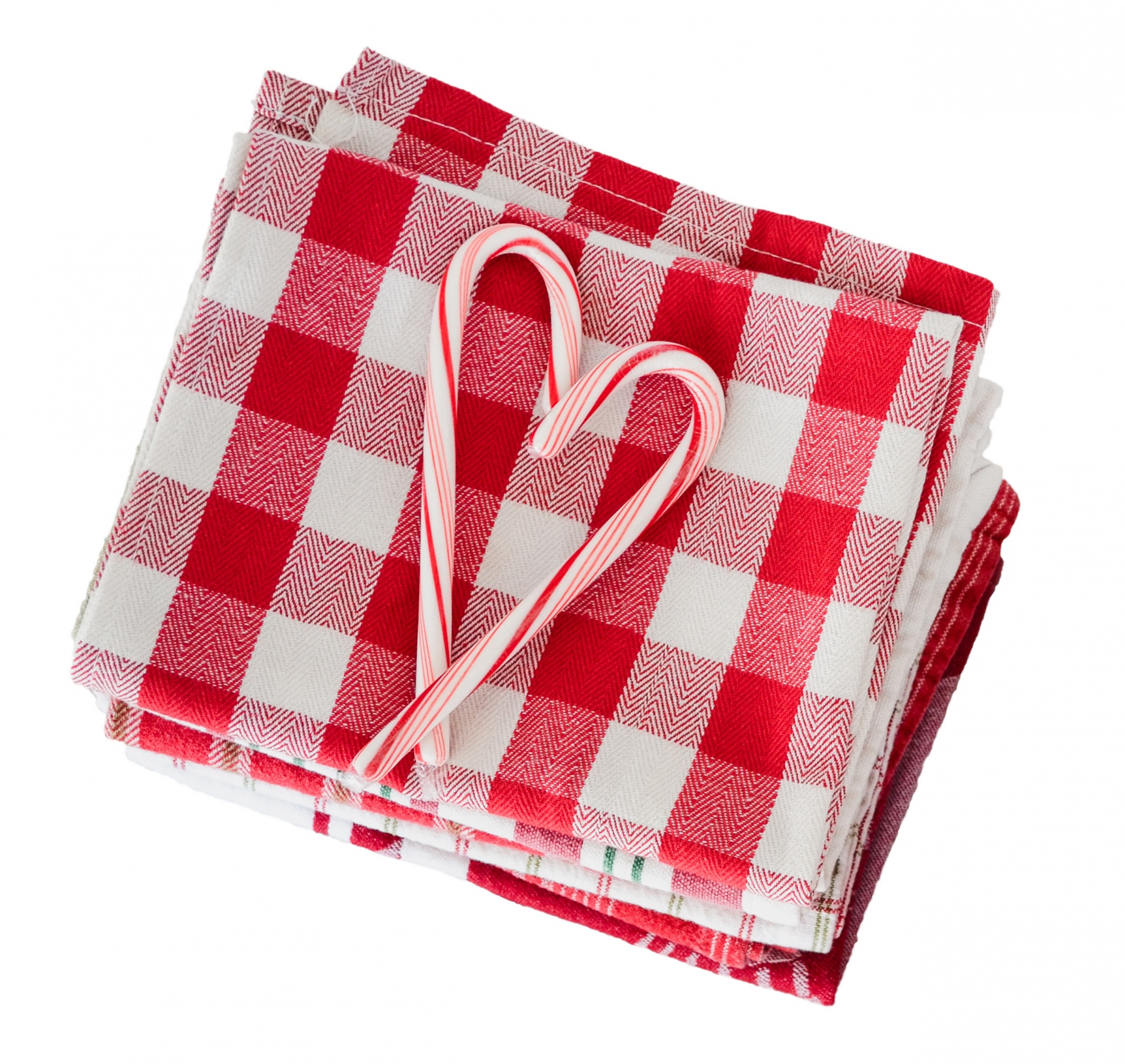 Candy cane heart and gingham checks red and white table cloth christmas background isolated