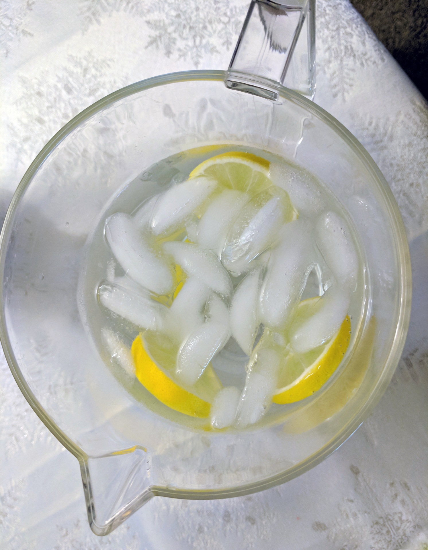 Pitcher of water with ice and slices of lemon