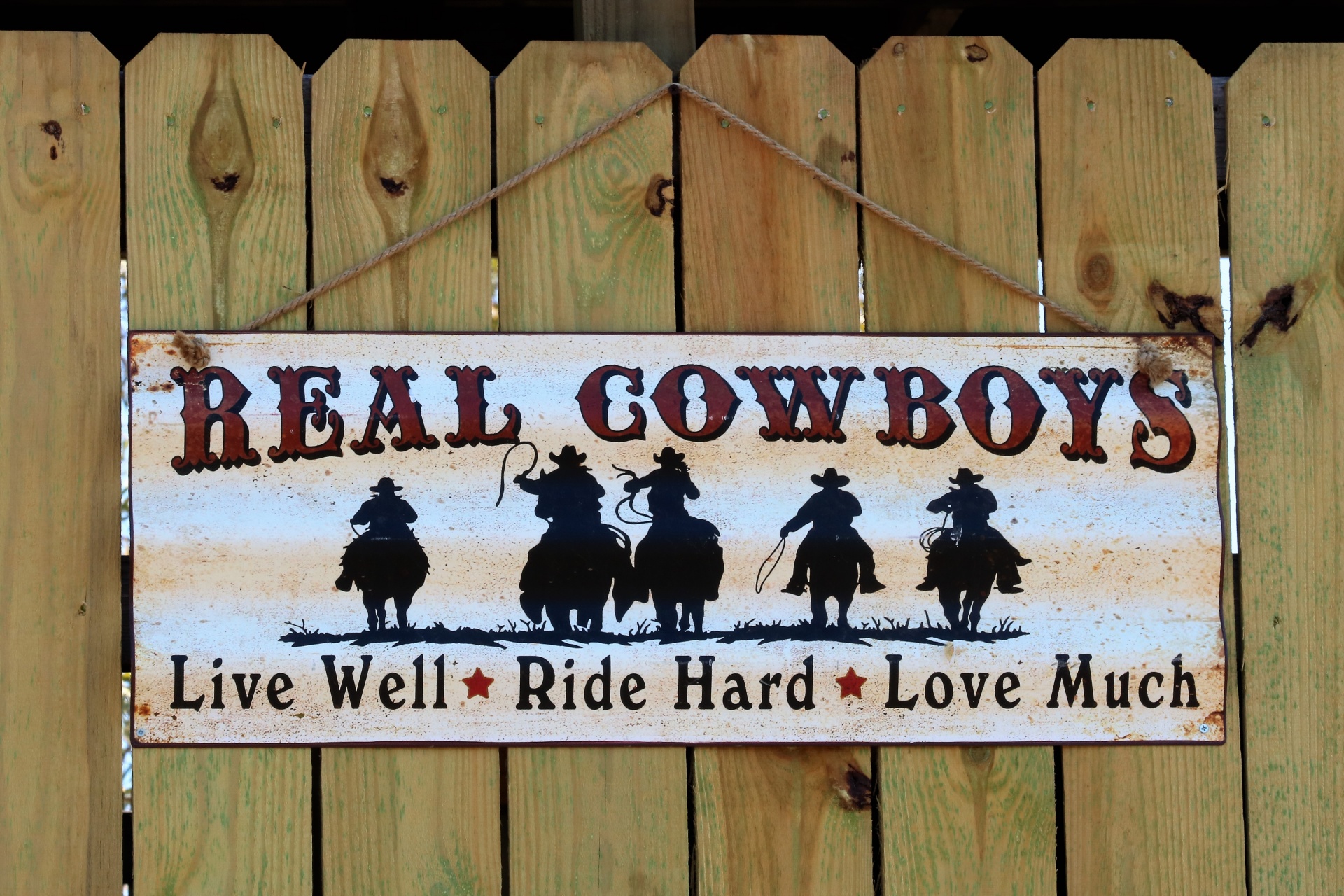 Real Cowboys Sign Hanging On Fence