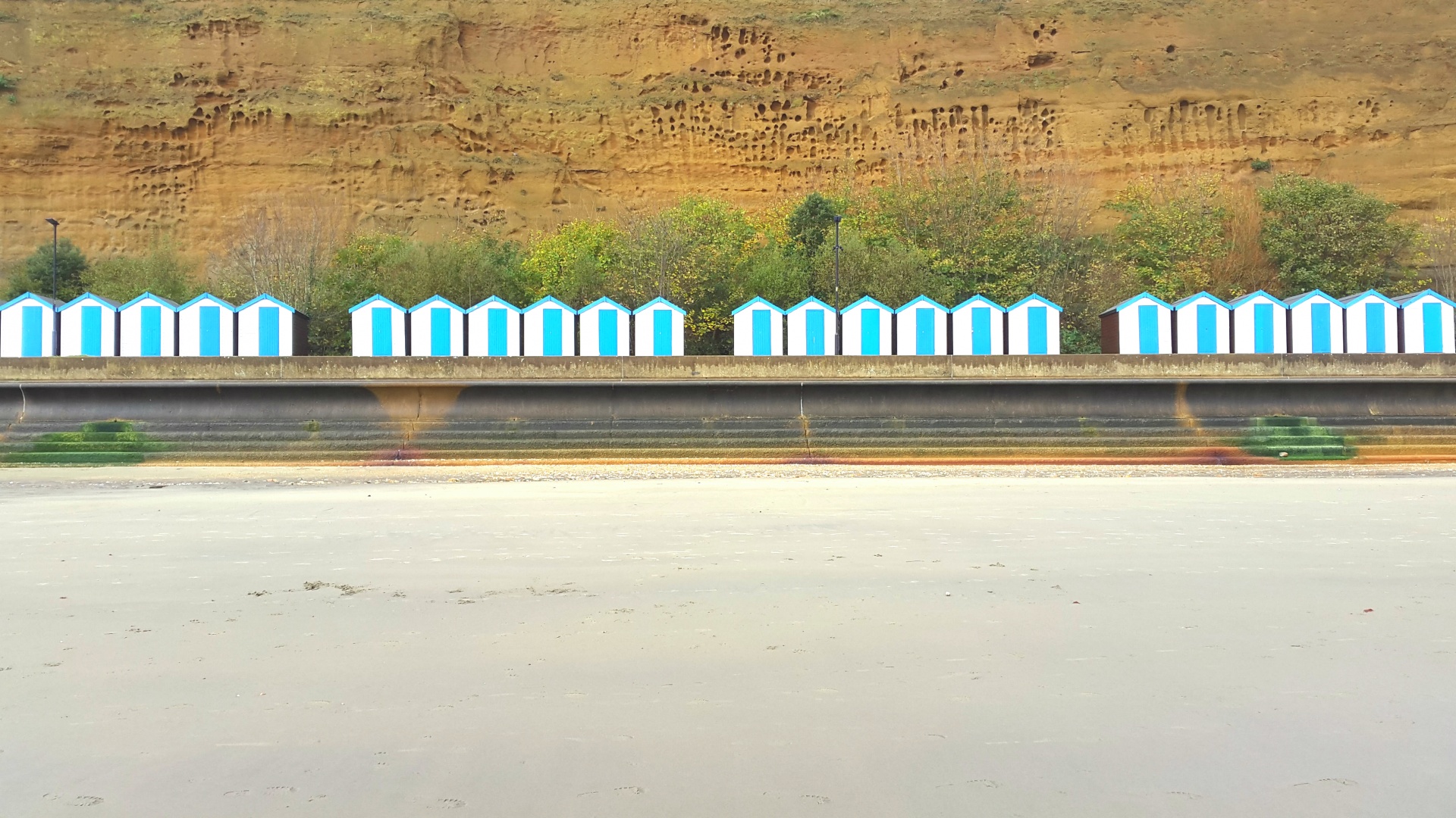 A row of white and blue beach huts