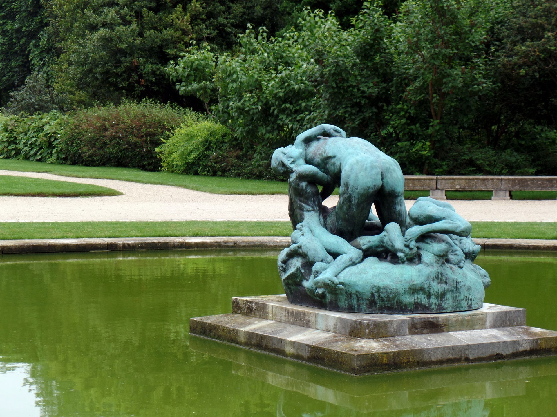 A bronze statue by Rodin in the middle of a pond