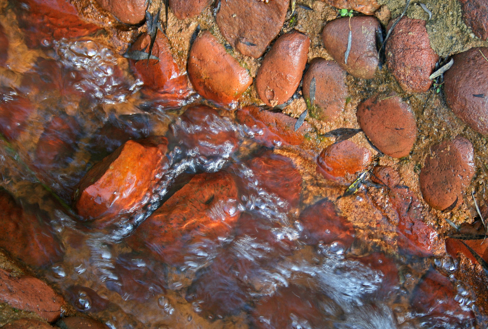 Wet Pebbles In Ditch With Water