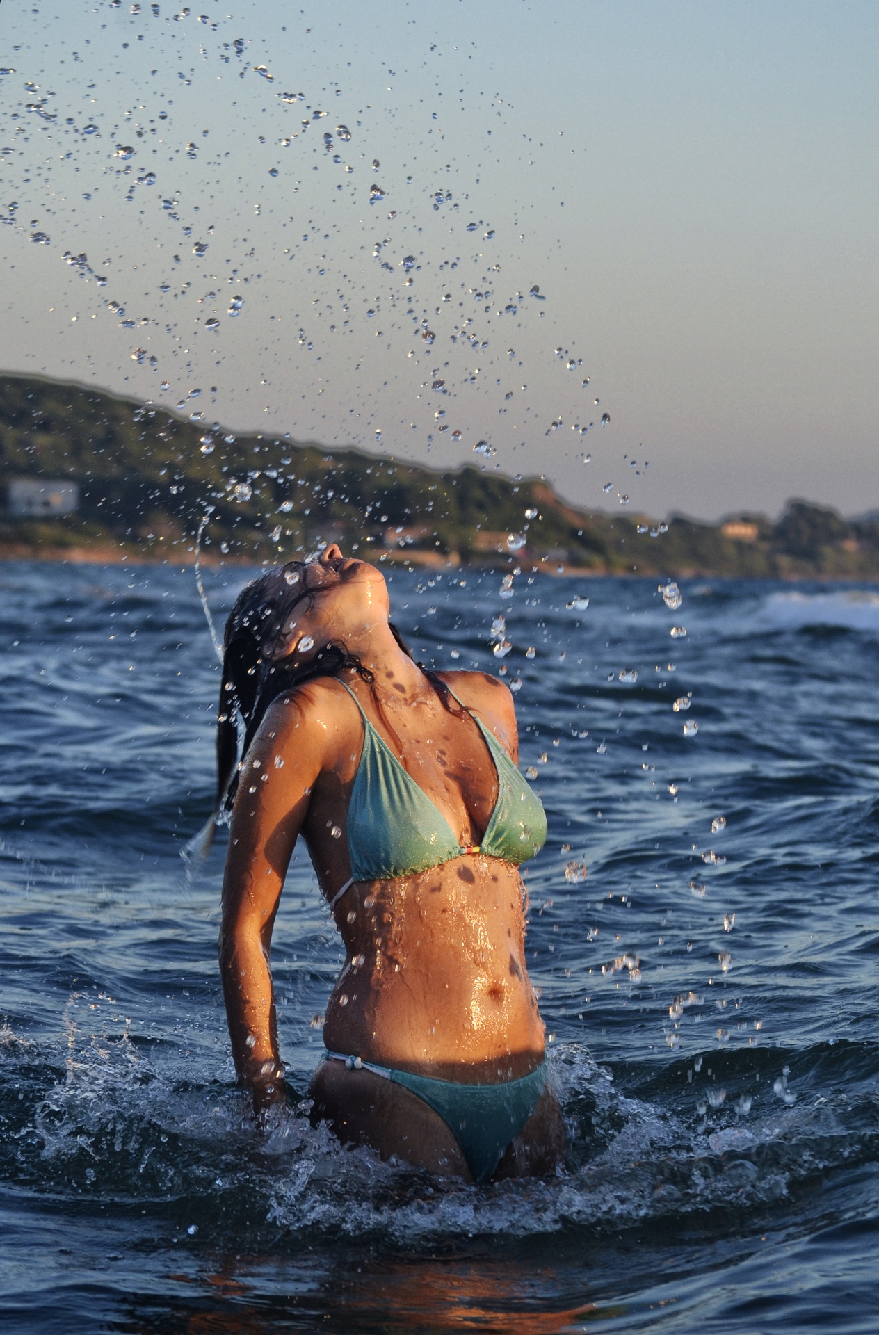 Woman Splashing Water In The Sea