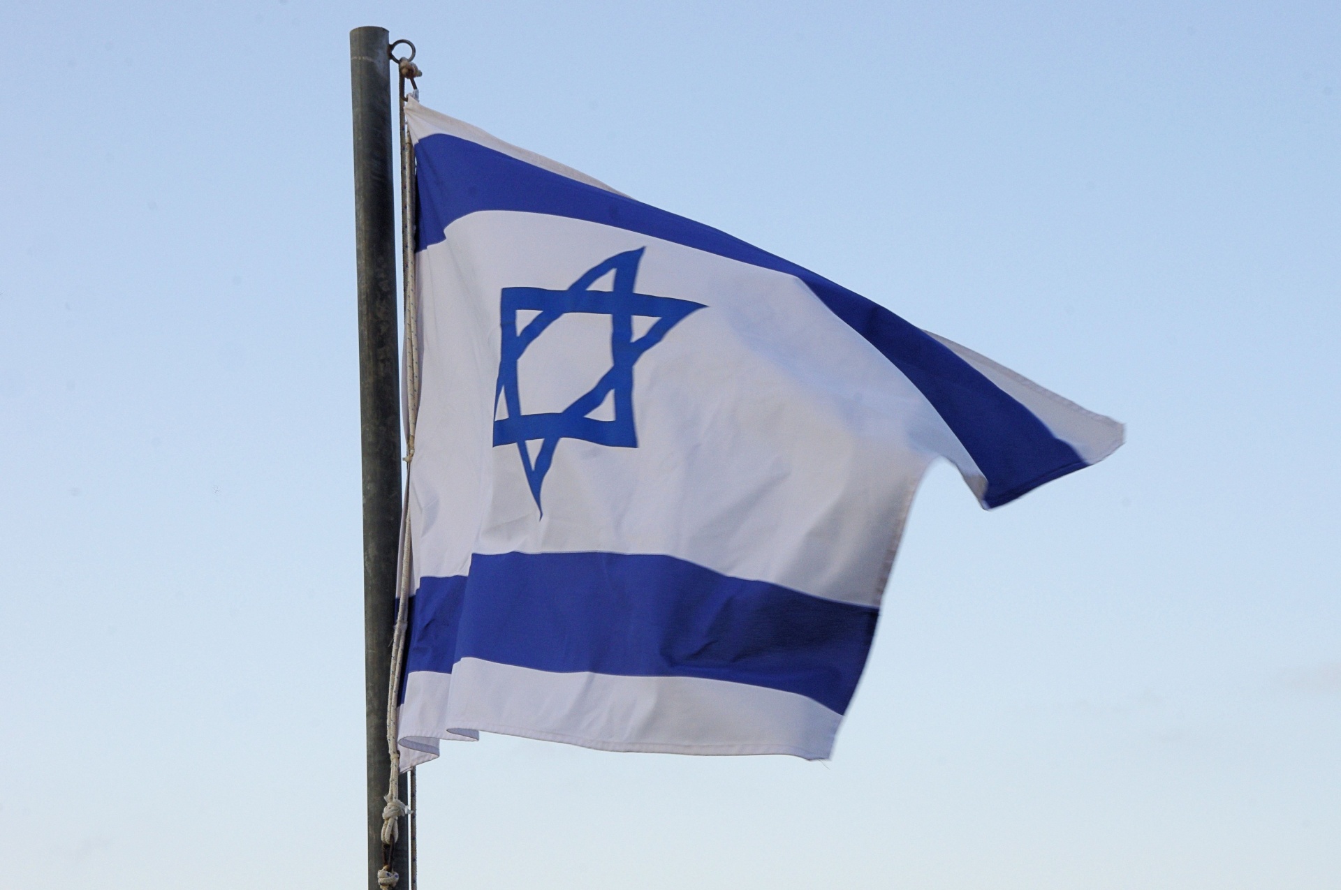 Israeli flag against blue sky