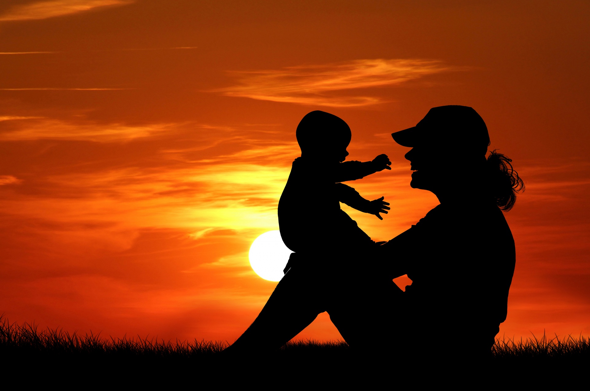 Mother and child silhouette at sunset