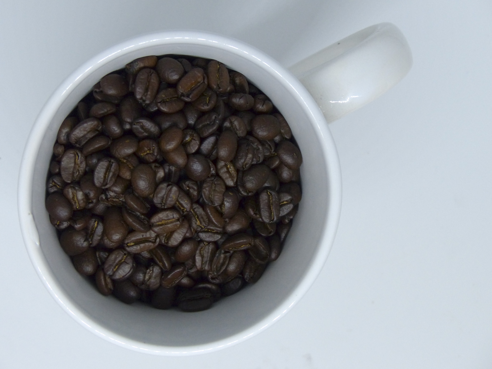 Top View Of Coffee Cup With Beans