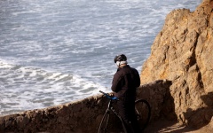 Bicyclist Looking At Ocean