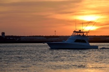 Boat Cruising At Sunset
