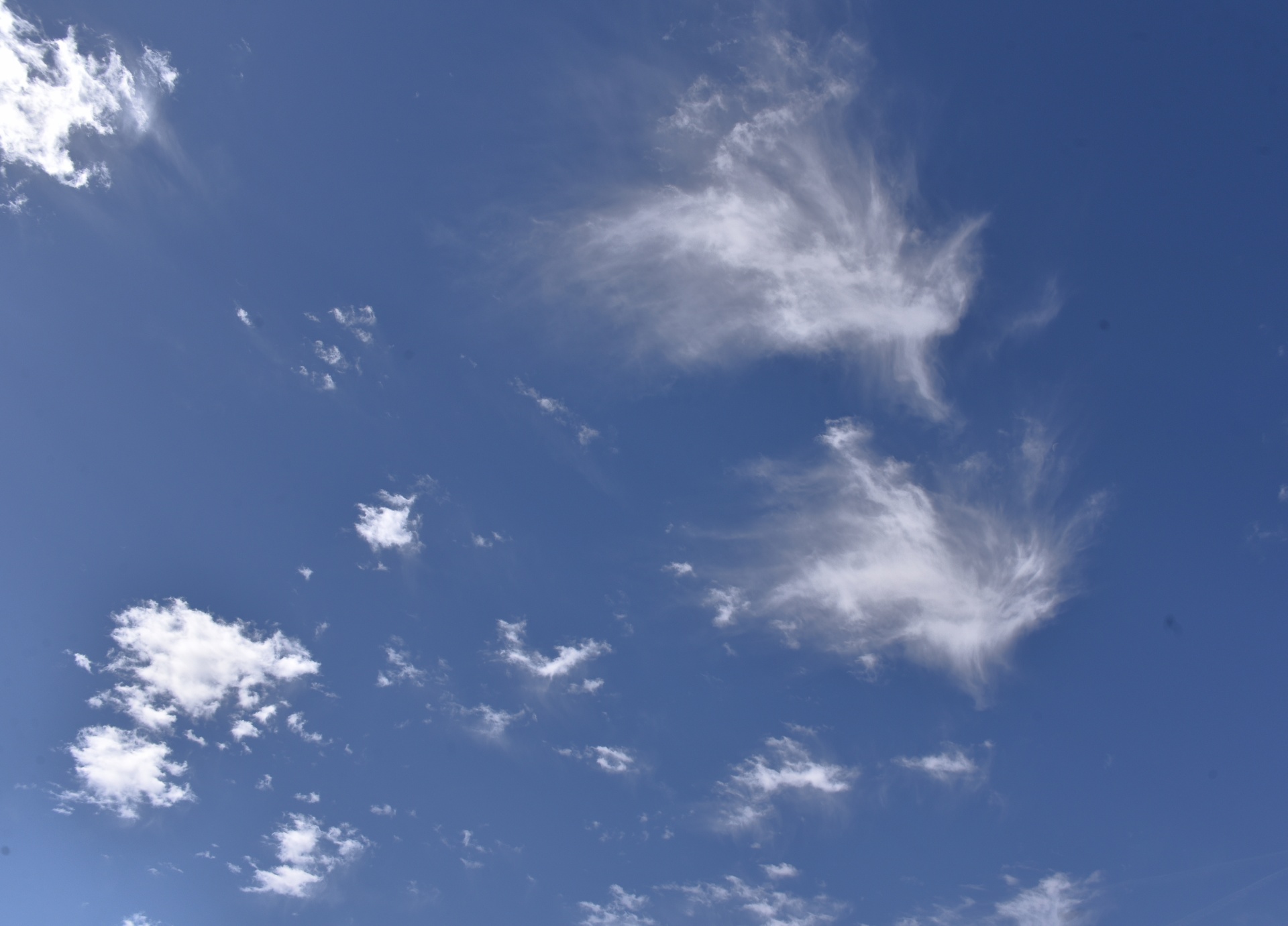 Cloud Wisps In Blue Sky Background